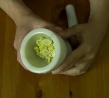 garlic and ginger in a mortar and pestle