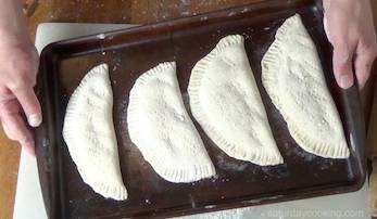 panzerotti laid out in a baking pan
