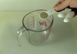 adding yeast to measuring cup