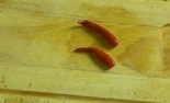 two pickled thai red peppers