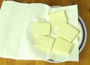 tofu on a paper-towel-covered plate