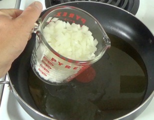 adding onion to skillet