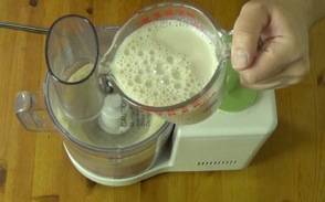 adding the soy milk to the ground cashews