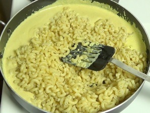 macaroni added to cheese sauce