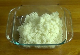 Transfering rice to a large glass dish
