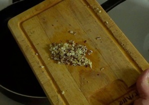 adding garlic and chili flakes to olive oil
