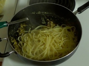 adding the pasta to olive oil mixture