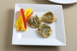 pate served on water crackers with slices of sweet pepper
