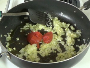 adding tomato paste