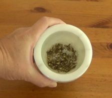 ground szechuan peppercorns in a mortar and pestle