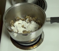 Adding flour to mushrooms