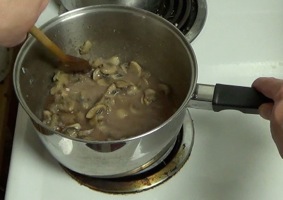 Mixing liquid with the flour and mushrooms