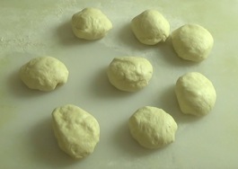 dough divided into 8 smaller pieces