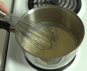 whisking soy milk and flour in a saucepan