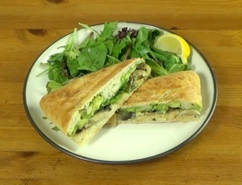 the finished sandwich with a side salad of mixed greens