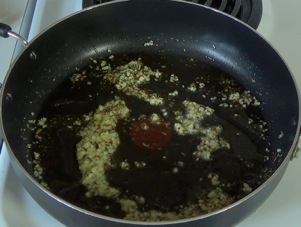 cooking the spices with the garlic